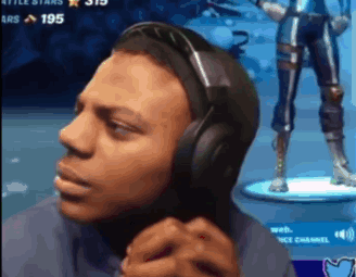 A Man Wearing Headphones Is Playing A Video Game And Making A Funny Face . GIF