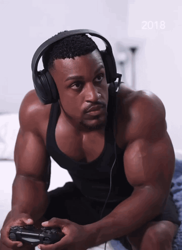 A Man Wearing Headphones Is Playing A Video Game With The Year 2018 On The Bottom GIF