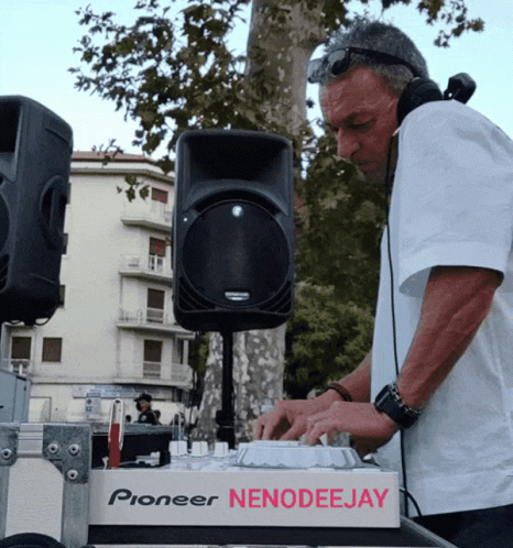 A Man Wearing Headphones Is Playing Music On A Pioneer Nenodeejay Machine GIF