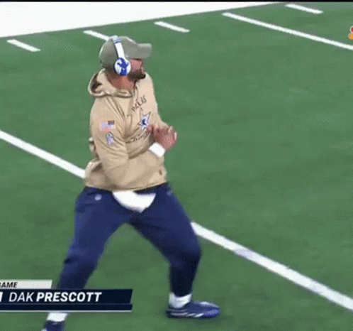 A Man Wearing Headphones Is Running On A Football Field With The Name Dak Prescott At The Bottom GIF