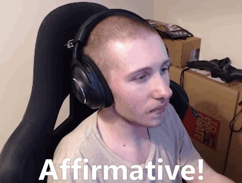 Man With Headphones Sitting With Affirmative Text GIF