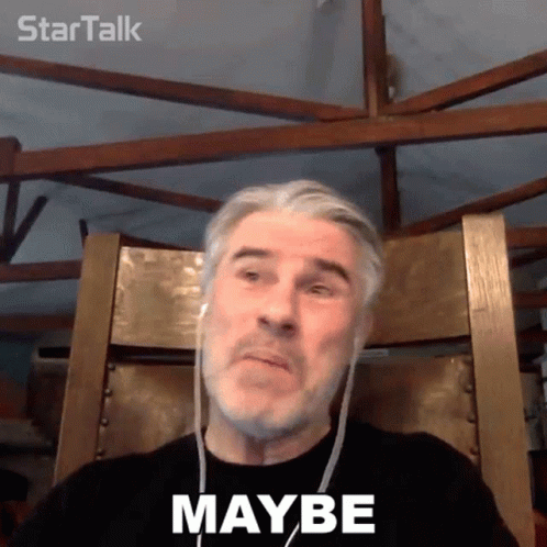 A Man Wearing Headphones Is Sitting In A Chair With The Word Maybe On His Face GIF