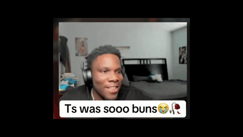 A Man Wearing Headphones Is Sitting In Front Of A Bed In A Room . GIF