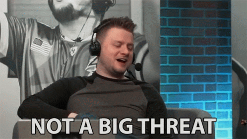 A Man Wearing Headphones Is Sitting In Front Of A Brick Wall And Says Not A Big Threat . GIF