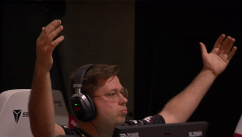 A Man Wearing Headphones Is Sitting In Front Of A Computer Monitor That Says Xl2666k GIF