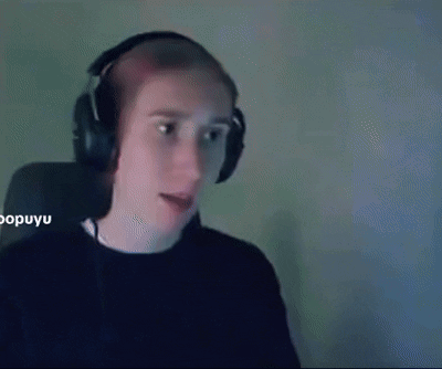 a man wearing headphones is sitting in front of a computer screen .
