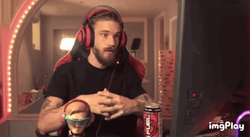 A Man Wearing Headphones Is Sitting In Front Of A Computer Screen With A Can Of Monster Energy Drink In Front Of Him GIF