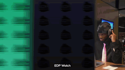 A Man Wearing Headphones Is Sitting In Front Of A Laptop With The Words Edp Watch Written Below Him GIF
