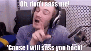 A Man Wearing Headphones Is Sitting In Front Of A Microphone And Making A Face . GIF