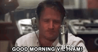 A Man Wearing Headphones Is Sitting In Front Of A Microphone And Says `` Good Morning Bob ! '' GIF