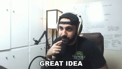 a man wearing headphones is sitting in front of a microphone and says " great idea "