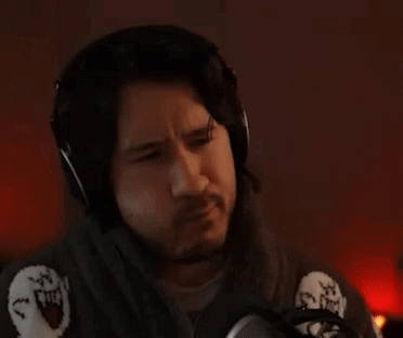 A Man Wearing Headphones Is Sitting In Front Of A Microphone And The Word Pass Is Above Him . GIF