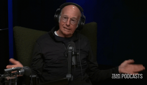 A Man Wearing Headphones Is Sitting In Front Of A Microphone With The Words Did Not Go Over Well Behind Him GIF