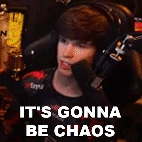 A Man Wearing Headphones Is Sitting In Front Of A Microphone With The Words It 'S Gonna Be Chaos Below Him GIF