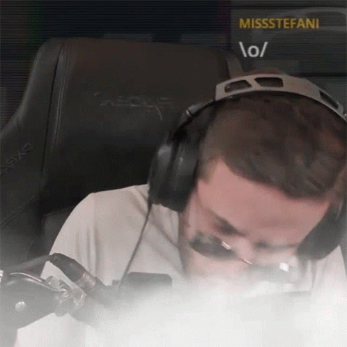 A Man Wearing Headphones Is Sitting In Front Of A Screen That Says Missstefani GIF