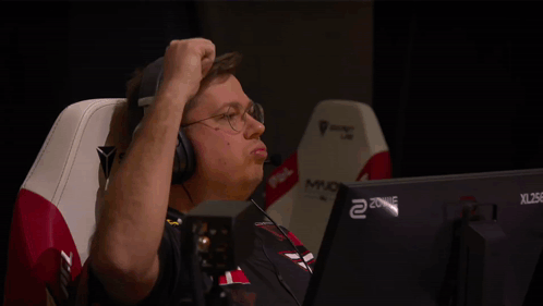 A Man Wearing Headphones Is Sitting In Front Of A Xl 256 Monitor GIF