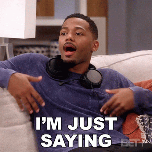 A Man Wearing Headphones Is Sitting On A Couch And Says " I 'M Just Saying " GIF