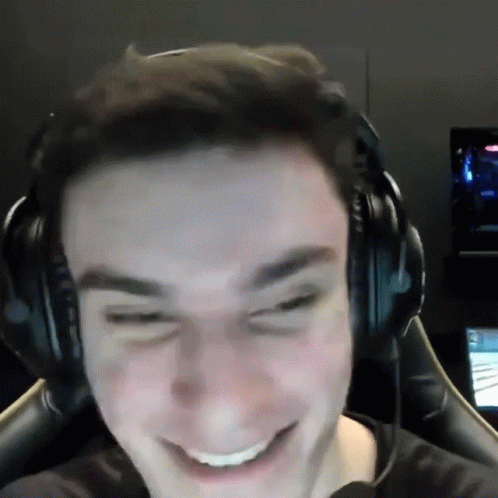 A Man Wearing Headphones Is Smiling And Making A Face GIF