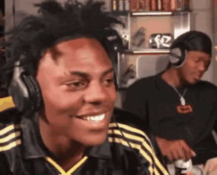 A Man Wearing Headphones Is Smiling While Another Man Looks On GIF
