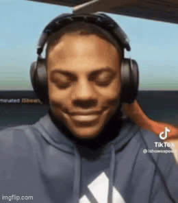 a man wearing headphones is smiling with his eyes closed