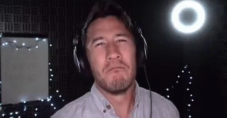 Man With Headphones Standing In Front Of Light GIF