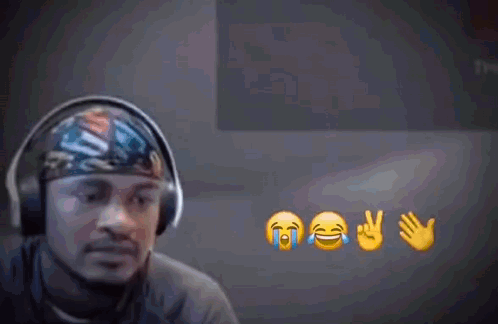 A Man Wearing Headphones Is Surrounded By Emojis Including One That Is Crying GIF