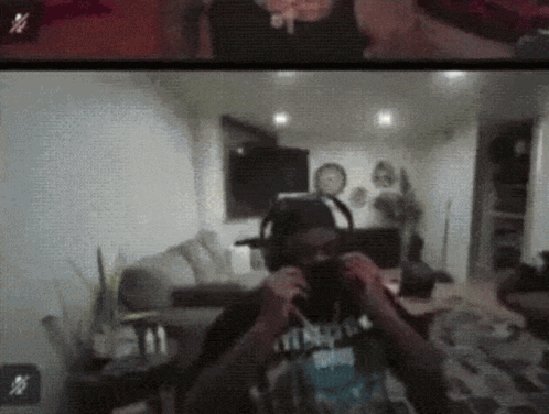 A Man Wearing Headphones Is Taking A Picture Of Himself In A Room GIF