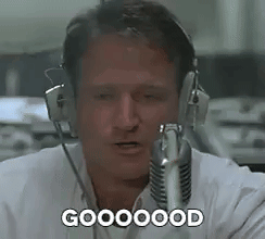 A Man Wearing Headphones Is Talking Into A Microphone And Saying `` Goooood '' . GIF