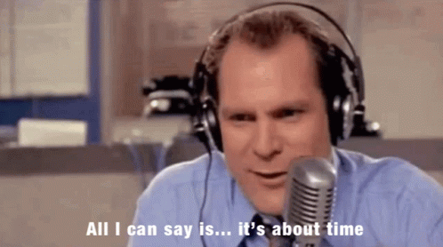 A Man Wearing Headphones Is Talking Into A Microphone And Says " All I Can Say Is It 'S About Time " GIF