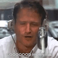 A Man Wearing Headphones Is Talking Into A Microphone And Says `` Good Morning '' . GIF
