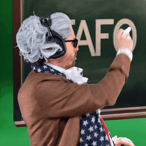 A Man Wearing Headphones Is Writing The Word Afo On A Green Board GIF