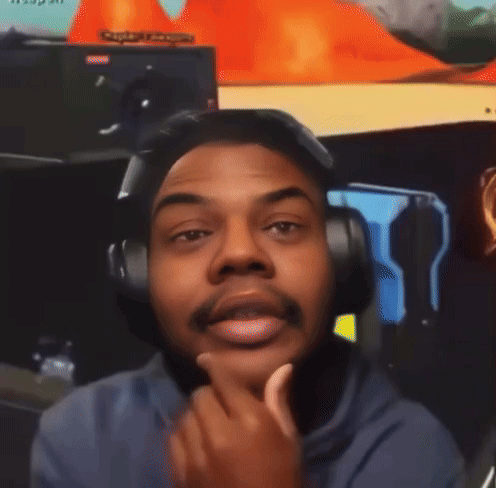 A Man Wearing Headphones Looks At The Camera With A Sign In The Background That Says ' Captain League ' GIF