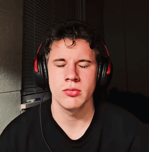 a man wearing headphones makes a funny face