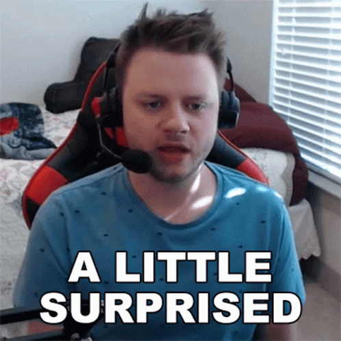 A Man Wearing Headphones Says A Little Surprised In Front Of A Window GIF