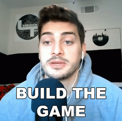 A Man Wearing Headphones Says " Build The Game " In Front Of A Microphone GIF