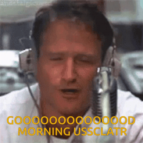 A Man Wearing Headphones Says Good Morning Ussclatr In Front Of A Microphone GIF