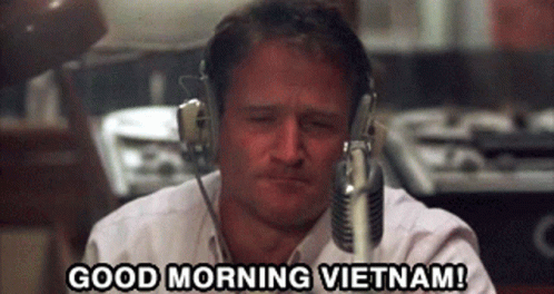 A Man Wearing Headphones Says " Good Morning Vietnam " GIF