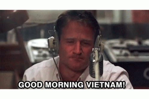 A Man Wearing Headphones Says " Good Morning Vietnam " GIF