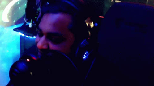 A Man Wearing Headphones Says " Here Comes The Party Pooper " GIF