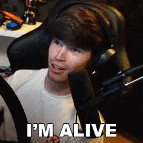A Man Wearing Headphones Says I 'M Alive GIF