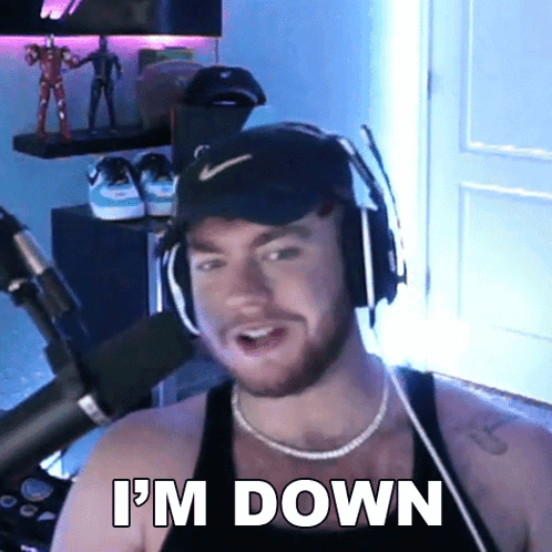 A Man Wearing Headphones Says I 'M Down In Front Of A Microphone . GIF