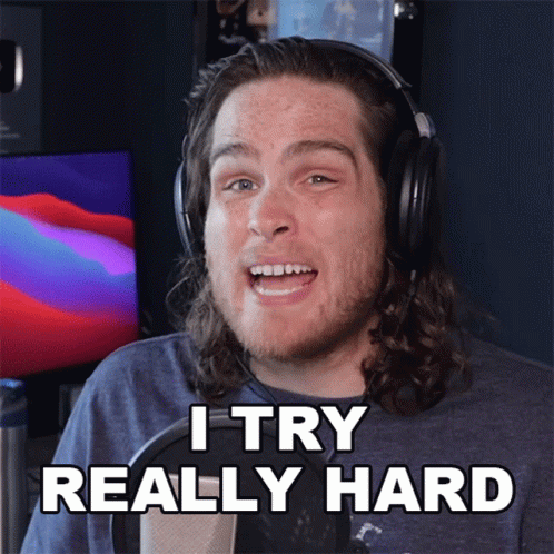 A Man Wearing Headphones Says " I Try Really Hard " In Front Of A Microphone GIF