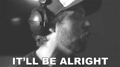 a man wearing headphones says it 'll be alright in a black and white photo