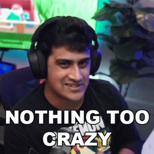 A Man Wearing Headphones Says " Nothing Too Crazy " In Front Of A Green Screen GIF