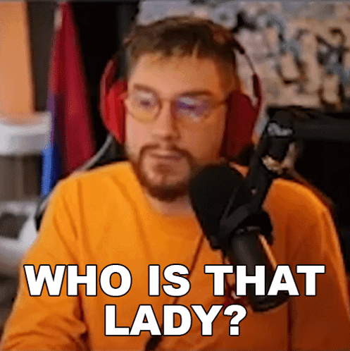 a man wearing headphones says who is that lady in front of a microphone