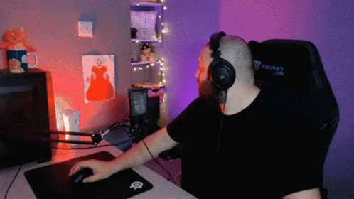 A Man Wearing Headphones Sits In A Secret Lab Gaming Chair GIF