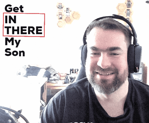A Man Wearing Headphones Smiles In Front Of A Sign That Says " Get In There My Son " GIF