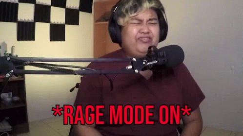 A Man Wearing Headphones Stands In Front Of A Microphone And Says " Rage Mode On * " GIF