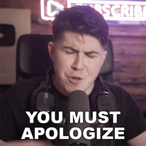 a man wearing headphones stands in front of a microphone and says " you must apologize "