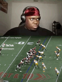 A Man Wearing Headphones Watches A Football Game On Tiktok GIF